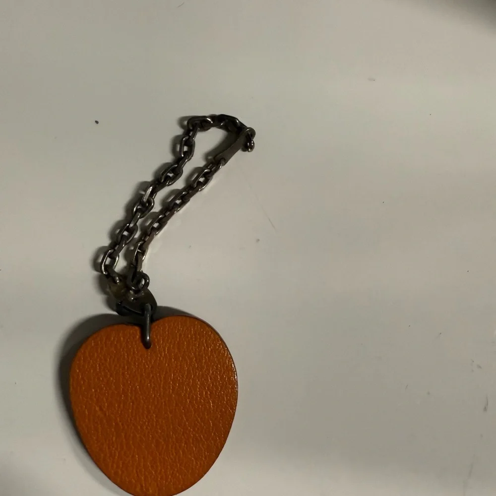 Hermes- AUTHENTIC 🍀 Orange Leather Fruit Charm with Green Leaf